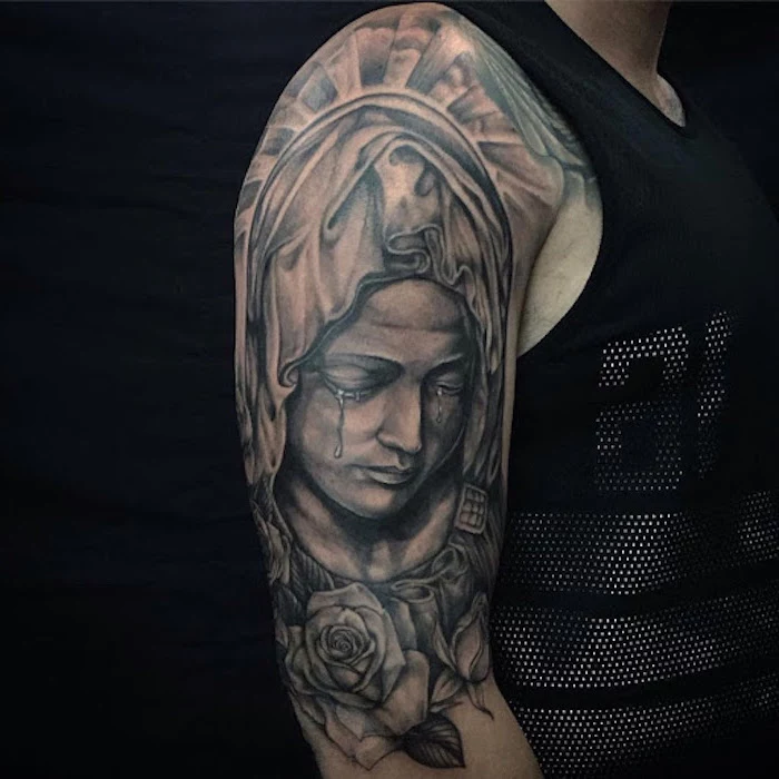 sleeve tattoo of crying virgin mary tattoos with meaning of life man wearing black top black background