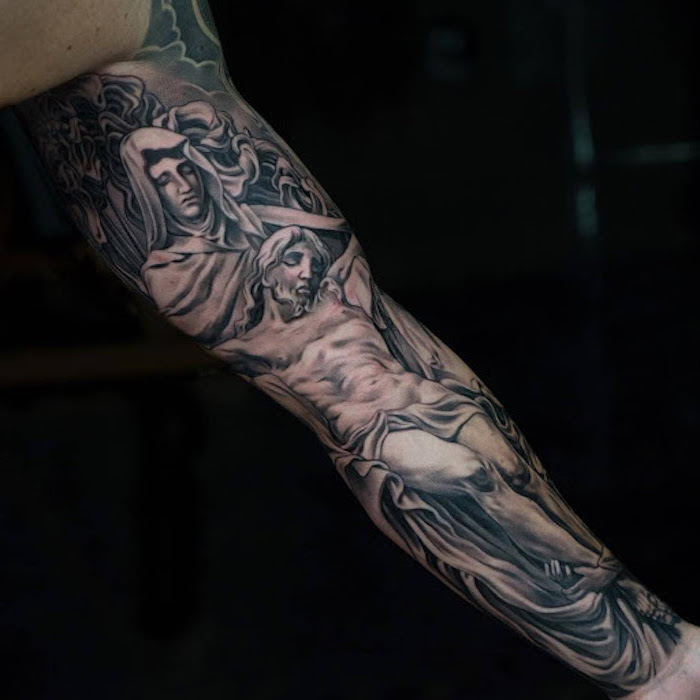 sleeve tattoo of jesus crucifiction tattoos that represent growth whole sleeve black background