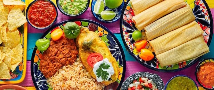 tamales mexican rice on colorful plates mexican dishes on colorful surface small bowls with different dips