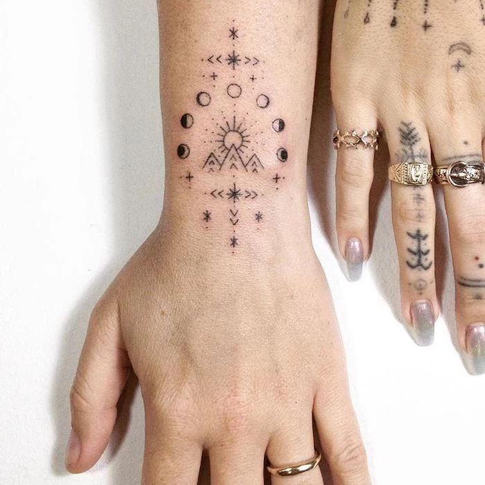 tattoo ideas with meanings hand wrist and finger tattoos phases of the moon geometric symbols mountain landscape