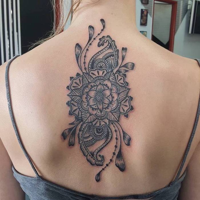 tattoos that represent growth intricate mandala tattoo tattooed on the back of woman wearing gray top