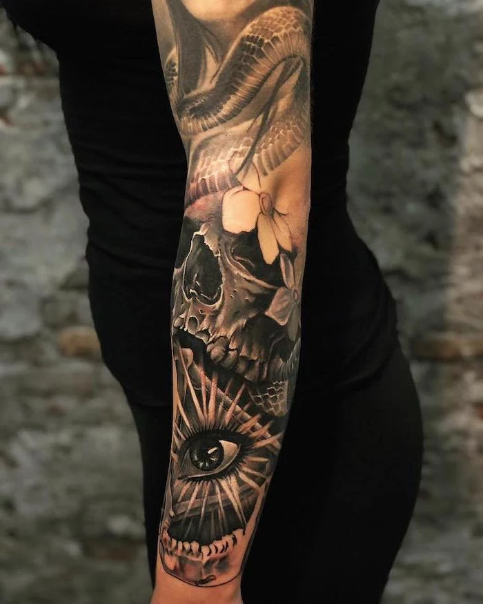 tattoos with deep meaning whole arm sleeve tattoo of dragon skull flowers all seeing female eye on woman wearing black leggings top