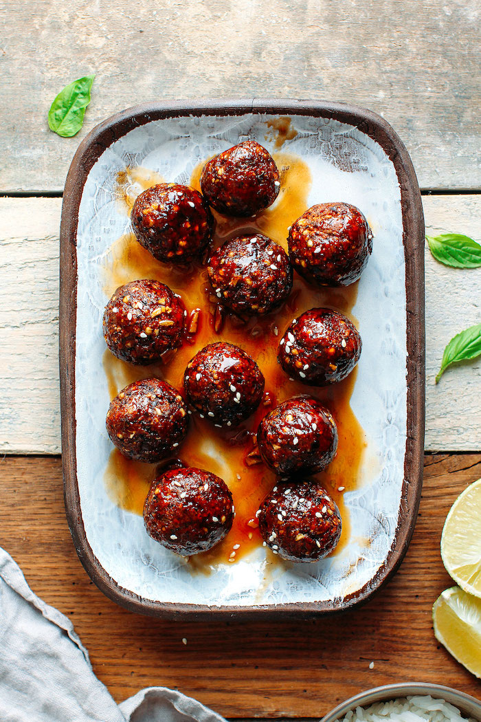 teriyaki meatballs placed on paper lined wooden tray vegan party appetizers wooden surface