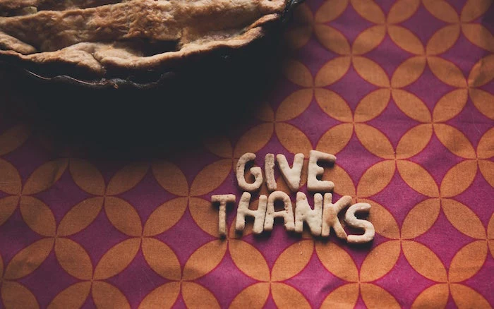 thanksgiving desktop wallpaper give thanks written with dough next to pie background in purple and orange