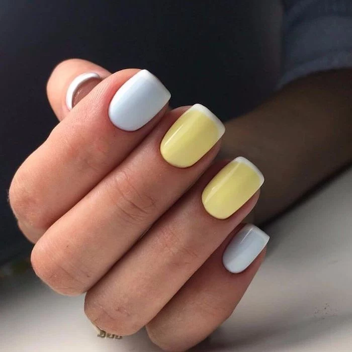 three nails in blue ring and middle finger with yellow nail polish cute nail ideas white french manicure short squoval shape