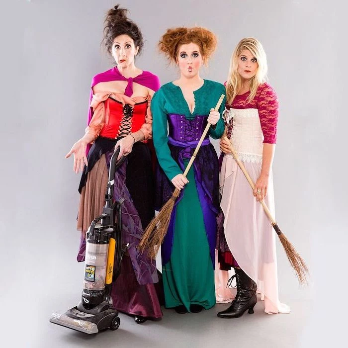 three women dressed as the witches from hocus pocus halloween costumes for 3 people photographed in front of white background