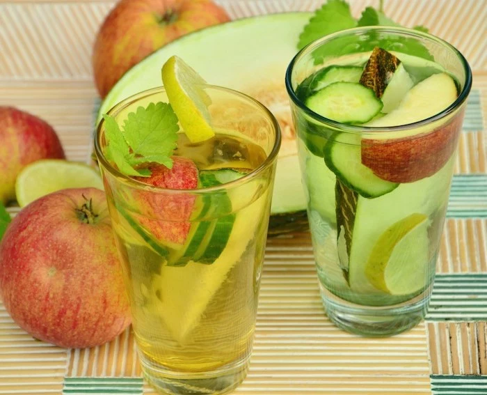 two glasses filled with apples cucumbers lemons melons how to detoxify your body melon and apples on the table