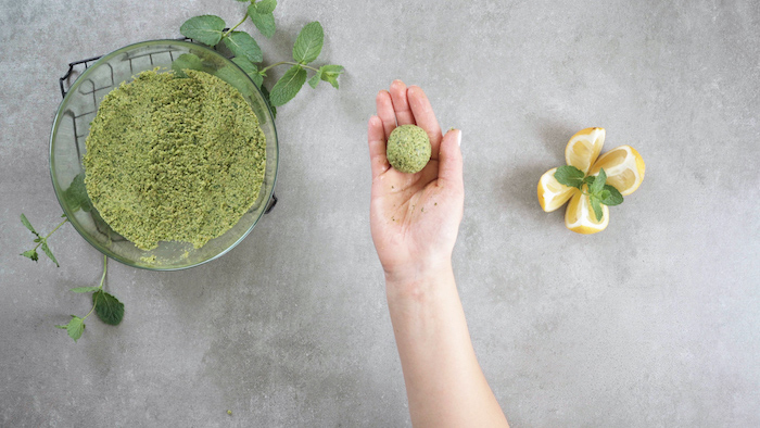 vegan hors d oeuvres glass bowl filled with chickpeas mixture female hand holding falafel ball into her hand