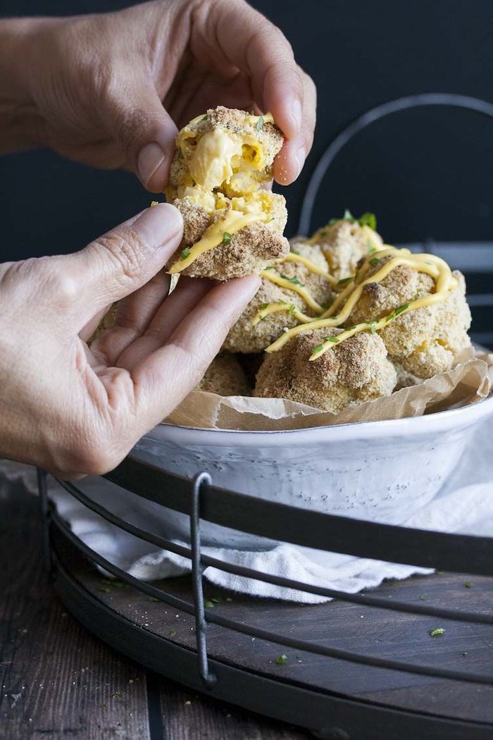 vegan party snacks mac and cheese bites dipped in breadcrumbs placed in white bowl with sauce