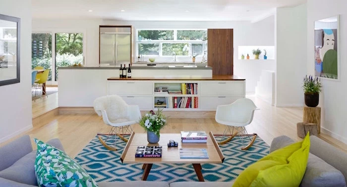 white armchairs and kitchen in all white gray sofa scandinavian minimalism blue and white carpet on wooden floor