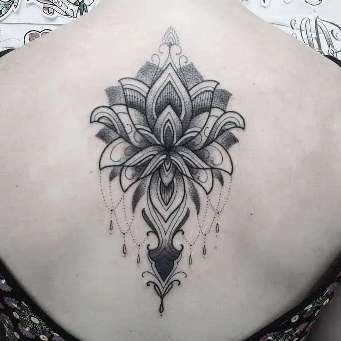 white background strength symbol tattoo lotus flower mandala tatoo on the back of woman