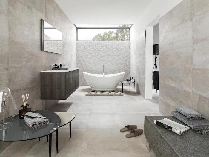 white bathtub with white 3d tiled accent wall behind it bathroom floor tile ideas light gray tiles on the walls and floor
