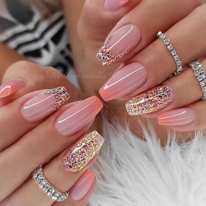 white fur under two hands with long square nails acrylic nail designs pink nails pink glitter on the ring fingers