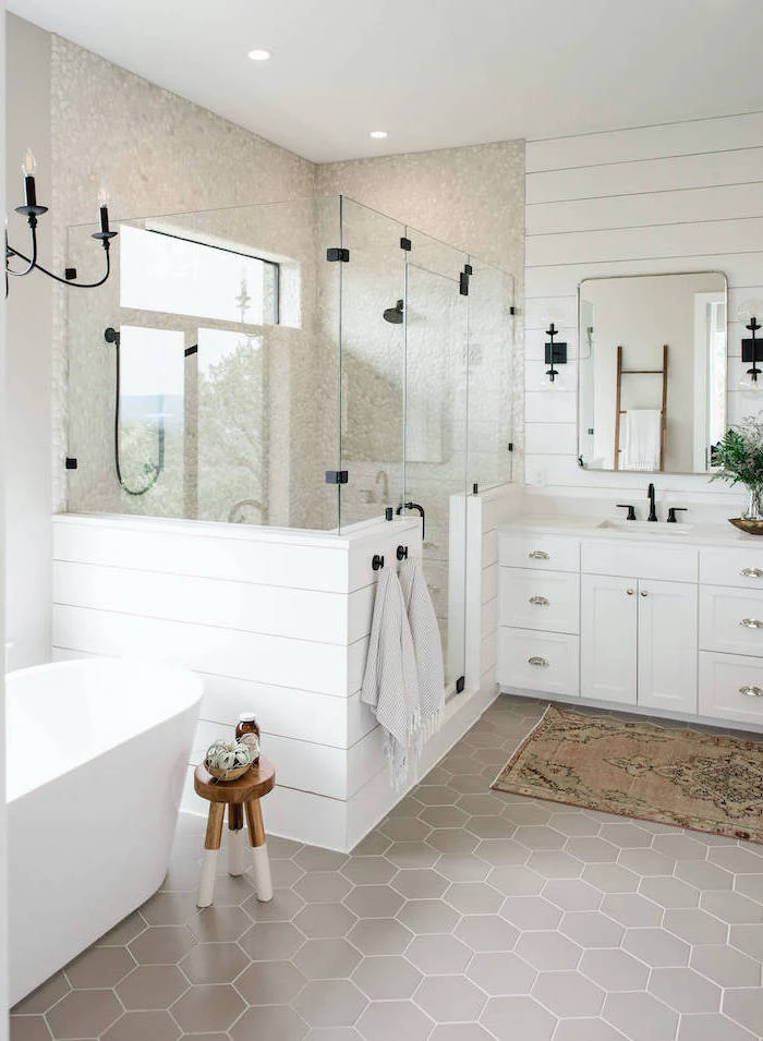 white shiplap on the wall behind the vanity gray honeycomb tiles on the flor cobble stone in the shower farmhouse bathroom ideas