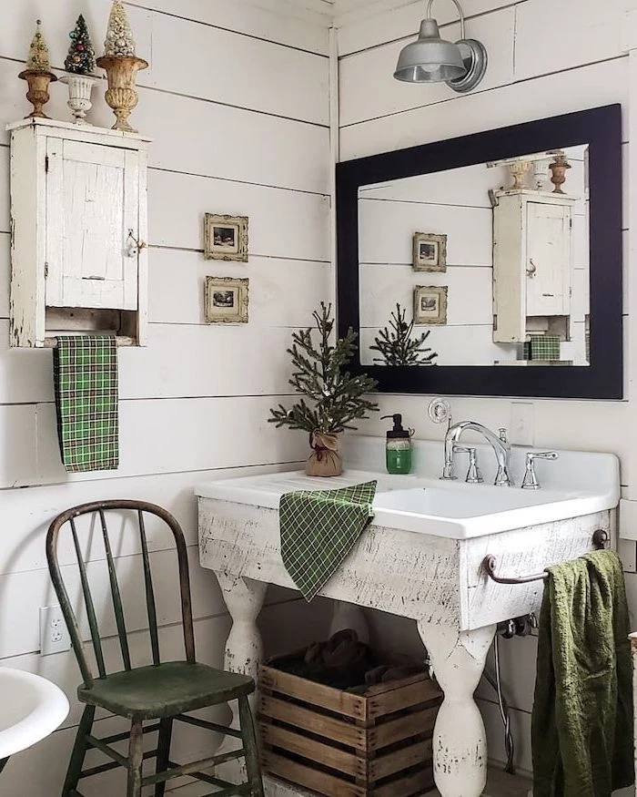 white shiplap on the walls vintage white wooden vanity with mirror above it with black frame farmhouse bathroom tile