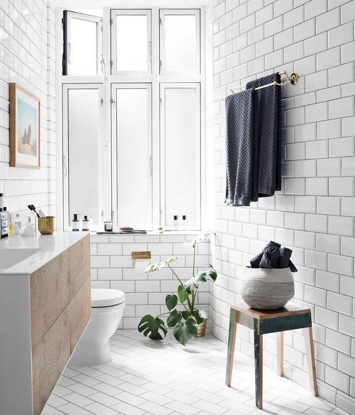 white subway tiles in small bathroom with floatinf wooden vanity scandinavian furniture small vintage wooden chair