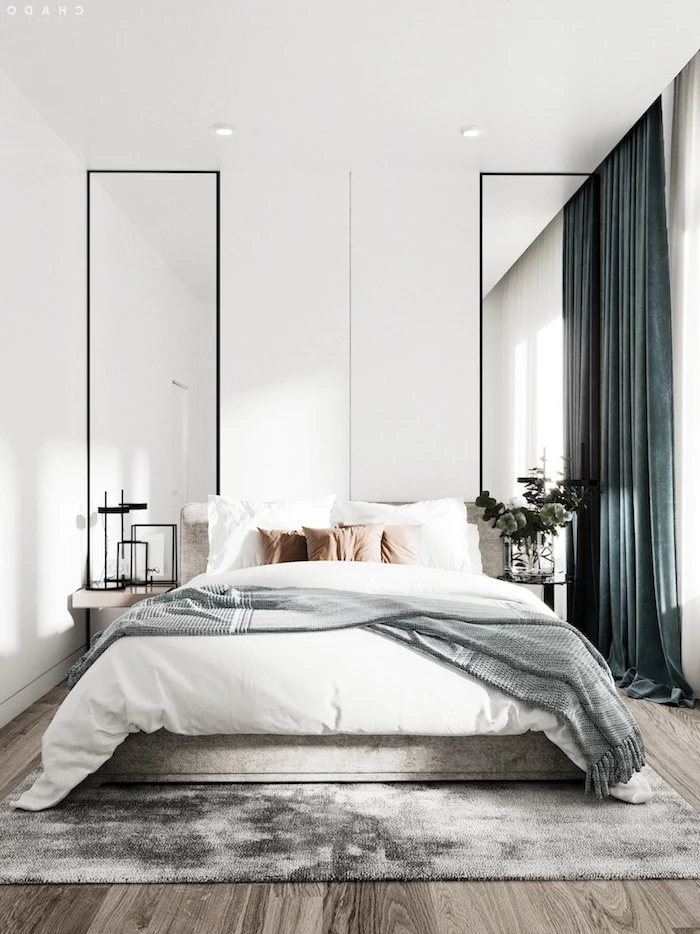white walls two large mirrors on both sides of bed scandinavian decor green velvet curtains gray rug on wooden floor