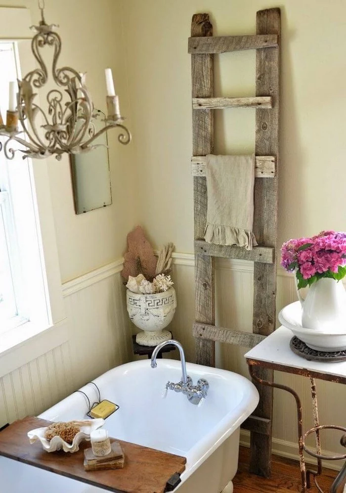 white walls vintage bath wooden ladder behind it for towels farmhouse bathroom decor vintage chandelier