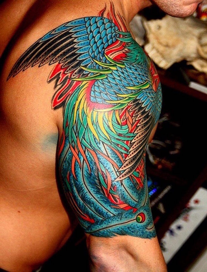 whole shoulder covered with tattoo of colorful wings small tattoo ideas for men blue green red yellow on the tattoo