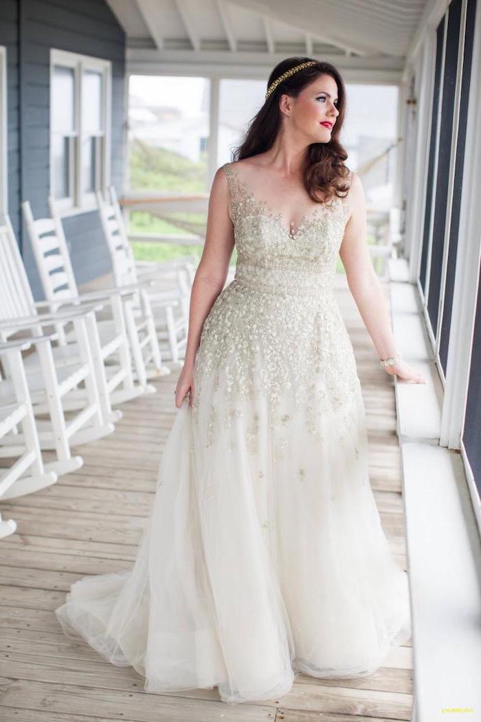 woman standing on a porch with medium length brown wavy hair long sleeve boho wedding dresses made of tulle and lace