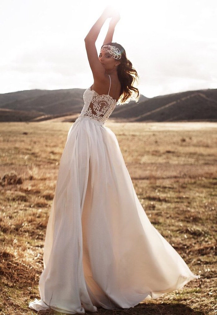 woman wearing white dress with lacy top bottom skirt made of tulle plus size boho wedding dress with brunette hair