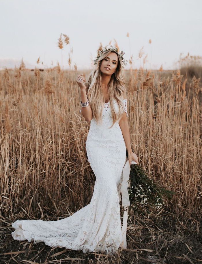 woman with long blonde wavy hair wearing floral crown plus size boho wedding dress wearing all lace white dress