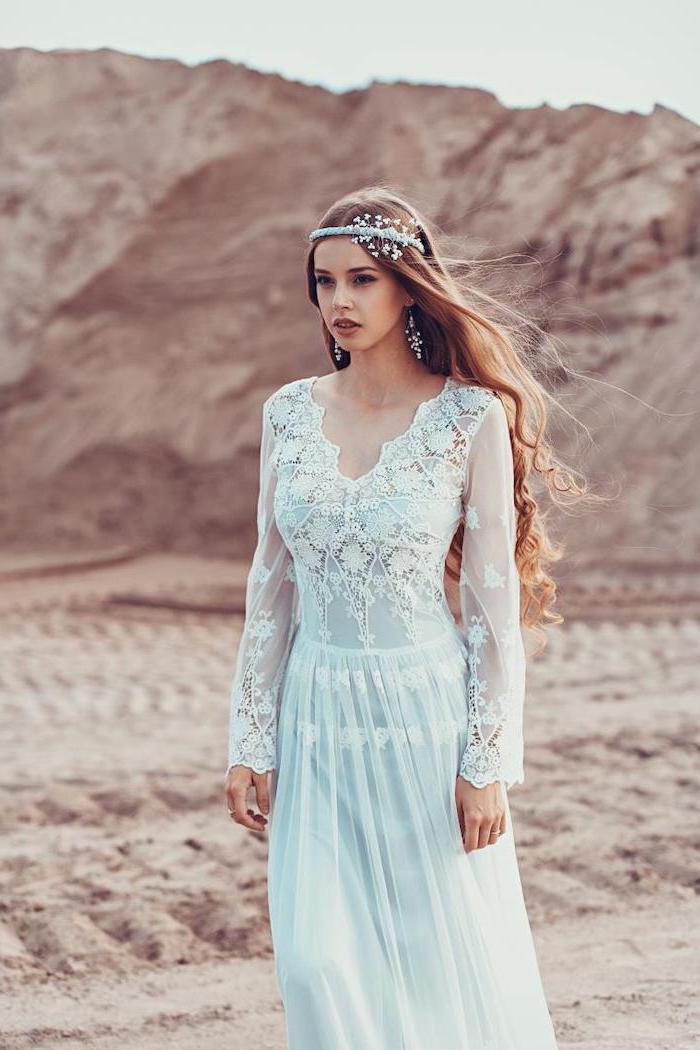 woman with long curly dark blonde hair wearing lace and tulle wedding dress with long sleeves unique wedding dresses