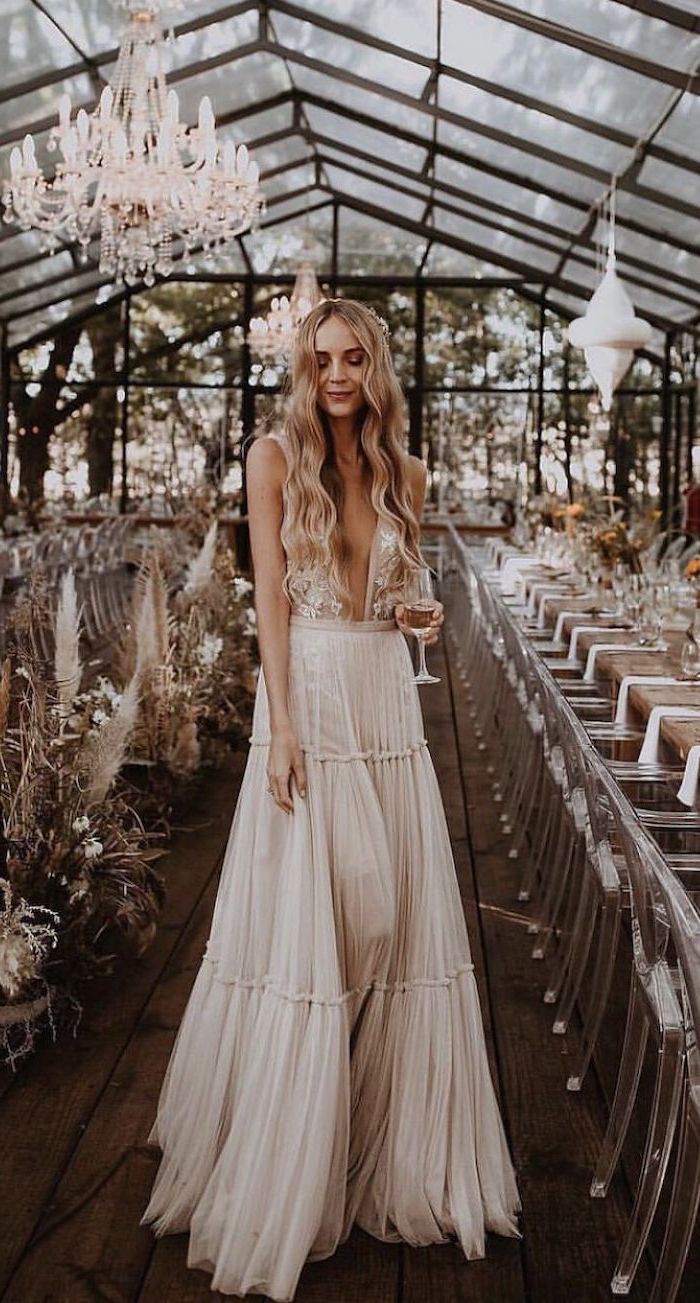 woman with long wavy blonde hair plus size beach wedding dresses wearing long dress with lacy top and bottom skirt made of tulle