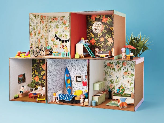 activities for toddlers at home five carton boxes built together as a doll house decorated with craft paper and mini furniture and dolls