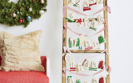 advent calendar ideas wooden ladder red and white ribbons tied from one end to the other small bags hanging from them