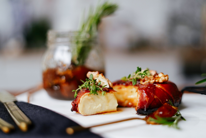 baked brie wrapped with prosciutto garnished with jam thyme walnuts thanksgiving food ideas