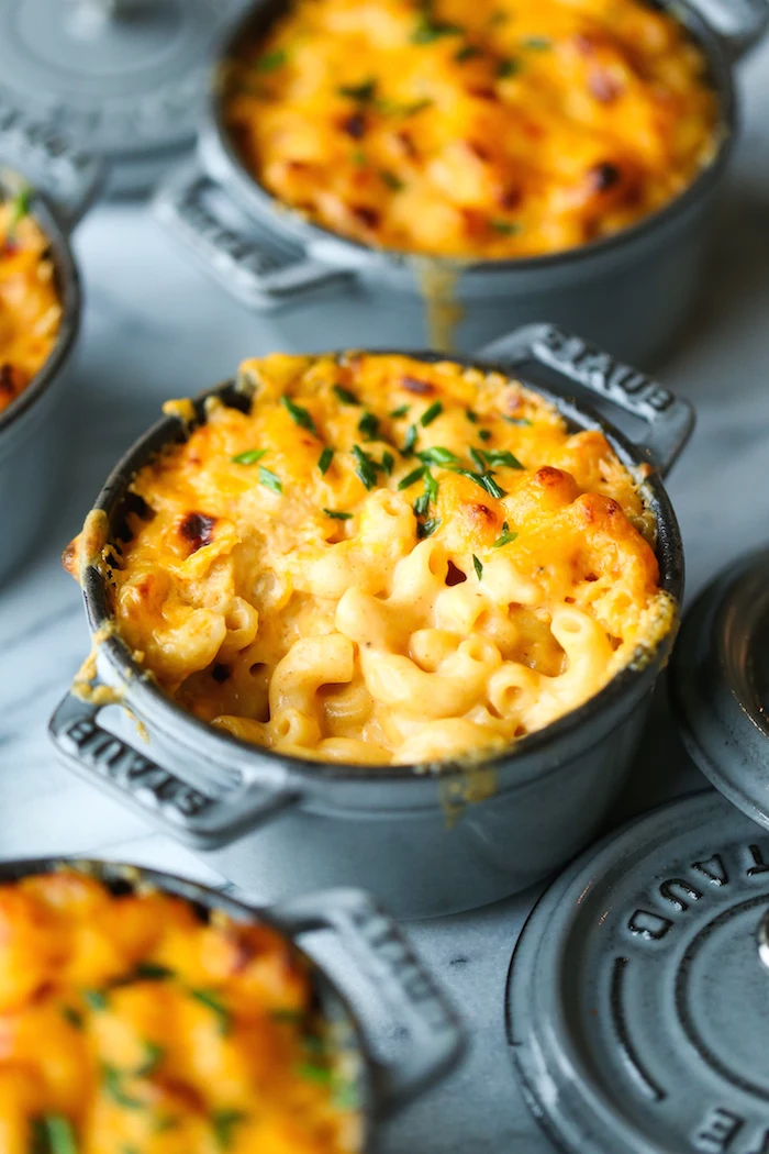 baked mac and cheese inside small black casserole dish thanksgiving vegetable side dishes placed on marble surface