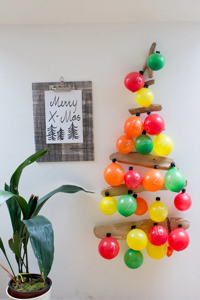 balloon advent calendar tree hanging on white wall advent calendar balloons in different colors attached to wood logs