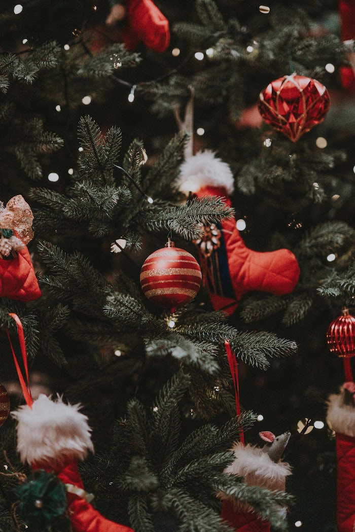 baubles in red and gold stockings hanging on christmas tree christmas wallpaper tumblr decorated with fairy lights