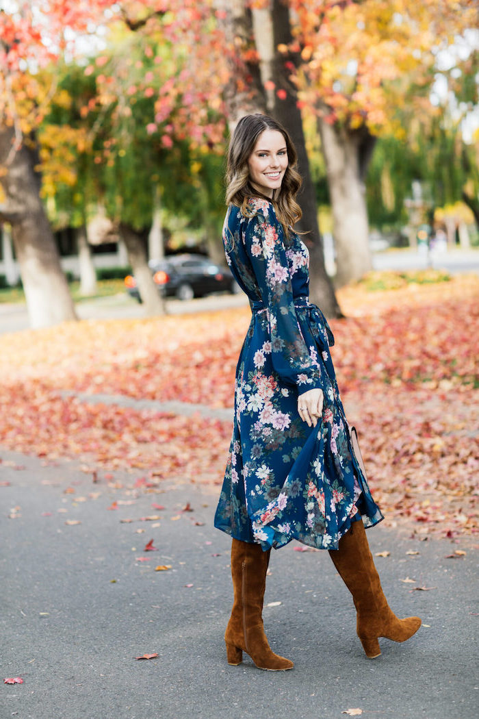 blue dress with pink flowers and long sleeves worn with brown velvet boots affordable wedding guest dresses woman with medium length brunette hair