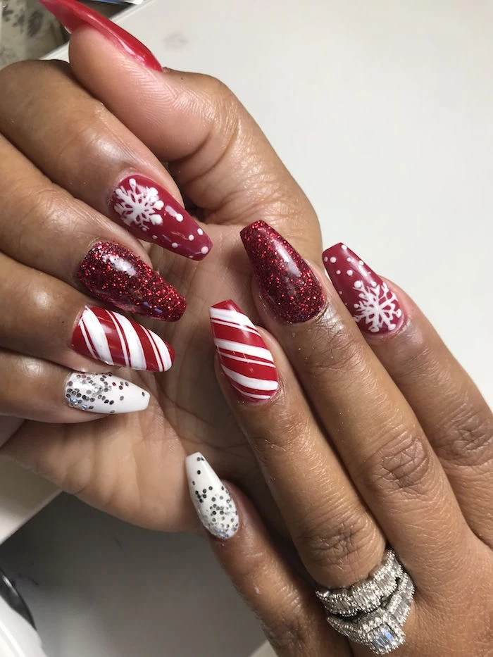 candy cane snowlakes decorations on medium length coffin nails holiday nail designs red white and red glitter nail polish