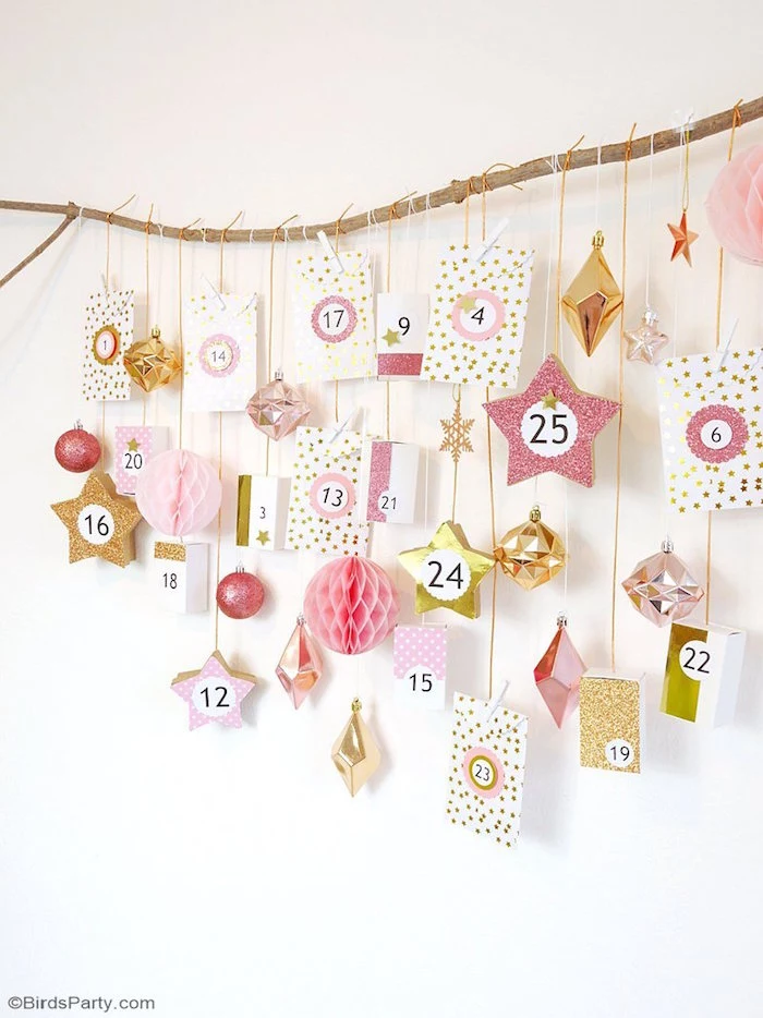 christmas tree advent calendar small boxes labeled with numbers hanging with white and gold string from wood branch
