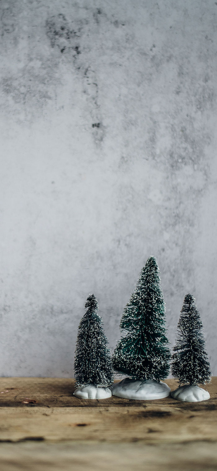 christmas wallpaper tumblr three small faux trees with branches with white tips placed on wooden surface