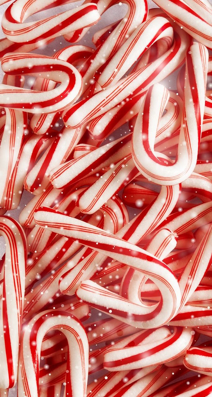 close up photo of lots of candy canes red and white aesthetic christmas wallpaper