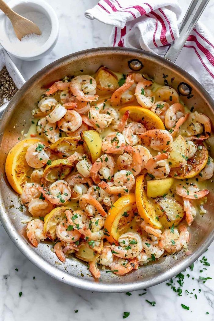cooked shrimp recipes shrimp with lemon wedges chopped parsley cooked in saucepan