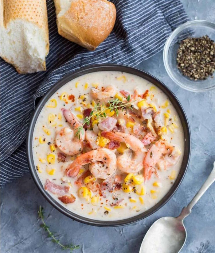 creamy shrimp soup with corn bacon how to cook raw shrimp poured inside black bowl garnished with thyme