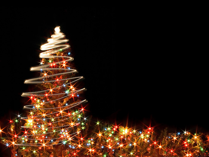 cute christmas wallpaper christmas tree covered with colorful lights photographed on black background