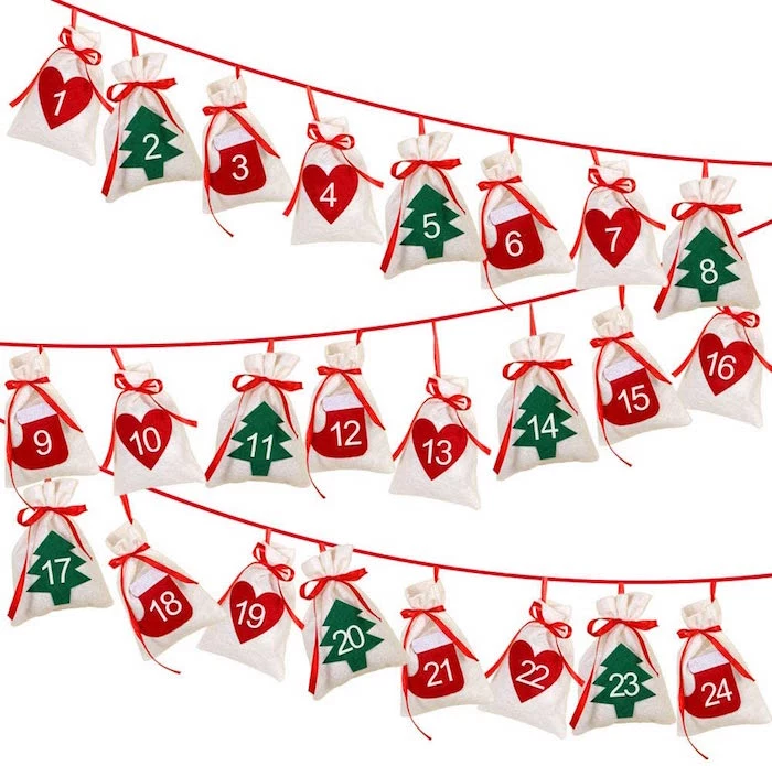 diy advent calendar red string hanging on white wall lots of bags attached to it with numbers from one to twenty four