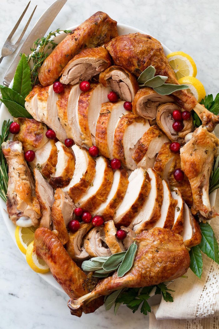 easy christmas dinner ideas turkey sliced into pieces arranged on white tray placed on white surface