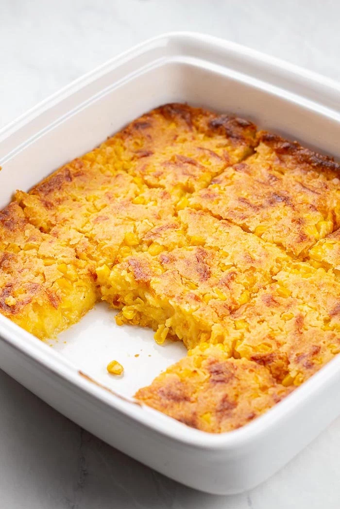 easy thanksgiving side dishes corn casserole baked inside white casserole piece missing placed on white surface