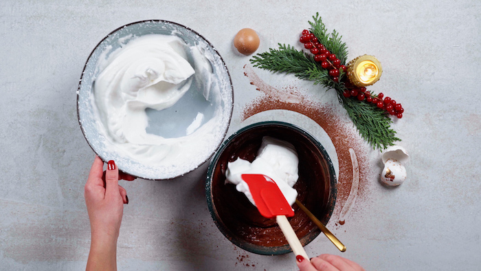 egg whites and egg yolks mixtures being mixed together in ceramic bowl christmas dinner party ideas silicon spatula