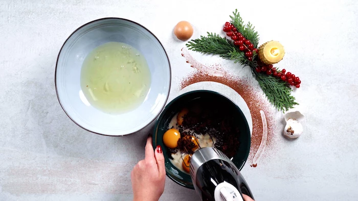 egg yolks being beaten with brown sugar in ceramic bowl christmas dinner party ideas egg whites in another bowl