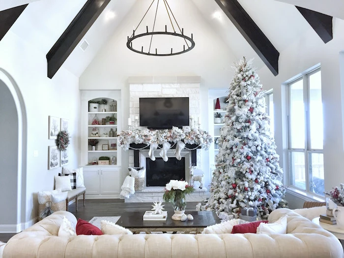faux white tree white christmas tree decorations with red baubles placed next to fireplace in front of white sofa
