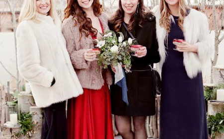 four women wearing coats black purple and red dresses affordable wedding guest dresses holding glasses