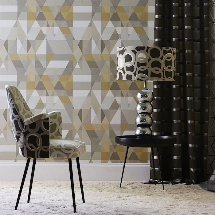geometrical wallpaper in yellow gray white vintage wallpaper armchair with circles on it matching lampshade on black round metal table